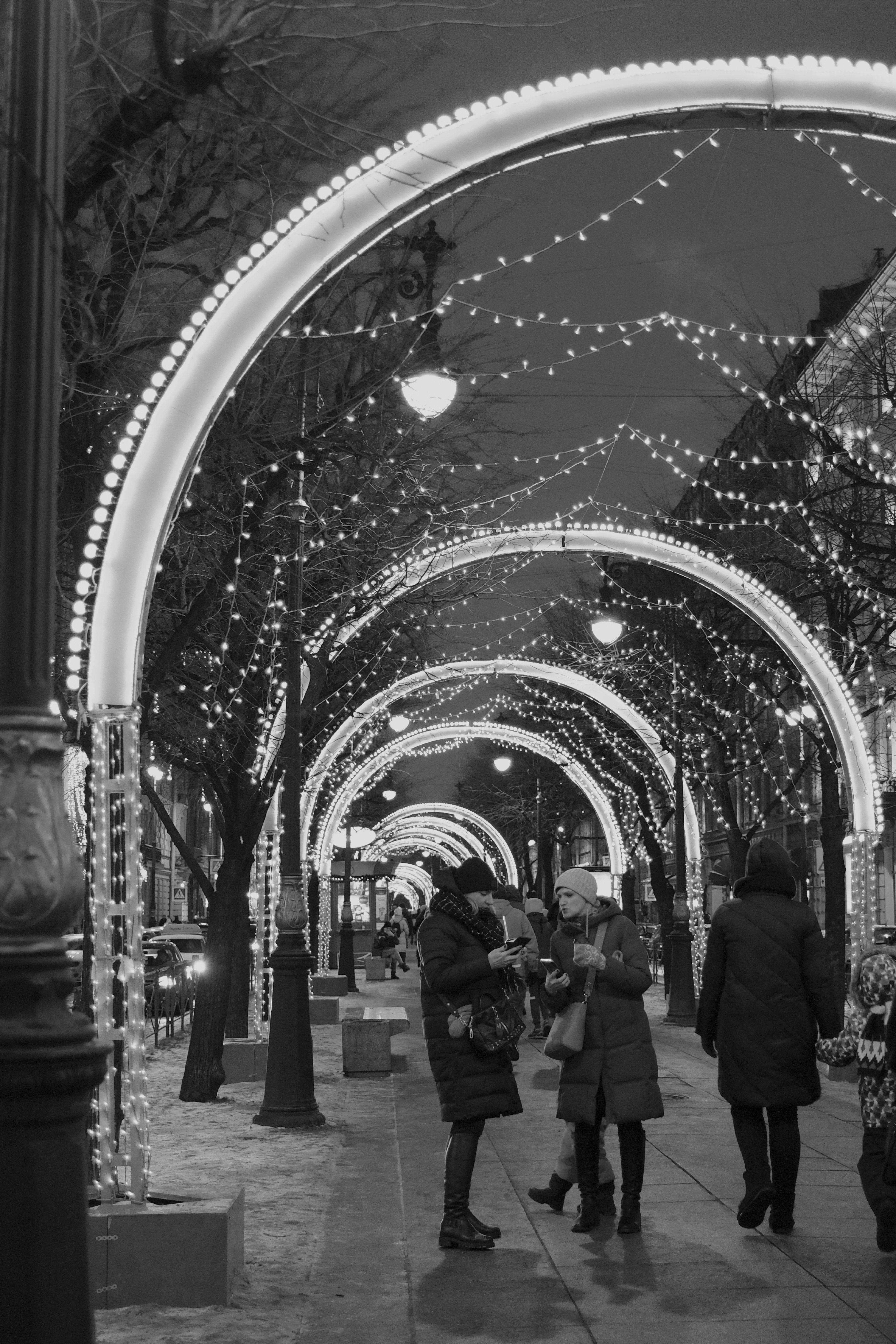 people walking on a street in grayscale photography